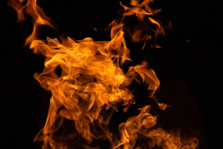 Isolated flames rising against black background with dynamic fiery shapes