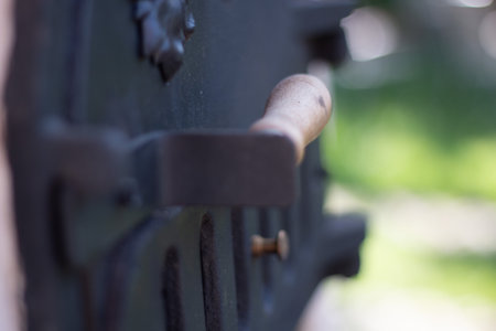 Close-up of antique metal door handle with ornate details and shallow depth of fieldの写真素材