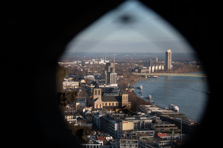 COLOGNE, GERMANY - DECEMBER 29, 2017: View of the Rhine River and Cologne cityscape through a pointed Gothic window opening of Cologne Cathedralの写真素材