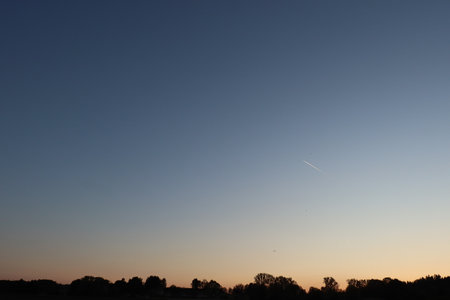 Evening sky at sunset with silhouette of tree line near Haag, Germany