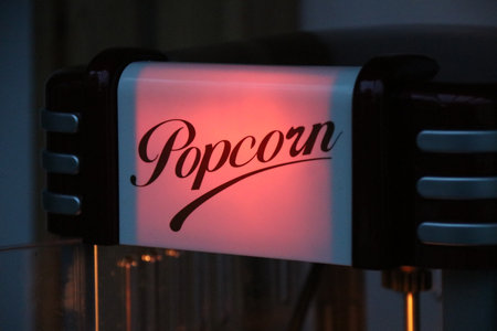 Illuminated popcorn machine sign in cinema style lighting