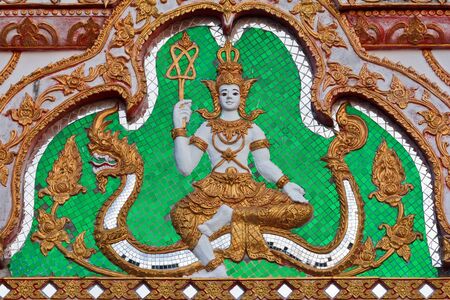 Sculptured god and dragon on Thai temple gate の写真素材