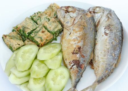 Fried mackerel with vegetable on plate.の写真素材