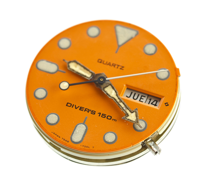 Macro closeup front of the old wristwatch on white background.