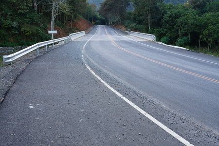 Asphalt road,straight to the curve in the countryside of Chiang Rai in Thailand.の写真素材