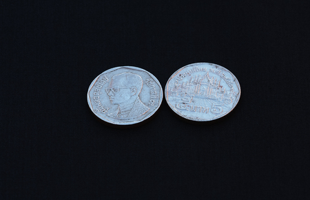 The five baht coins of Thailand in the past on black background.の写真素材