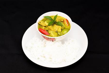 Thai food.Green curry with pork and rice noodles.の写真素材