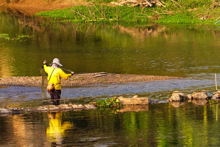 Phayao,Thailand - February 15 : Unidentified a Thai woman is preparing to fish in a shallow river,on February 15,2017,in the village of Sop Bong,Chiang Kham District,Phayao,Thailand.のeditorial素材
