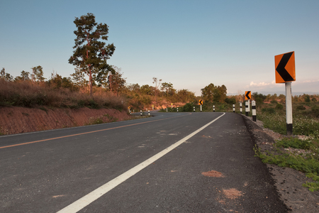 Warning sign.On the road ahead is the curve marker in the countryside of Thailand.の写真素材