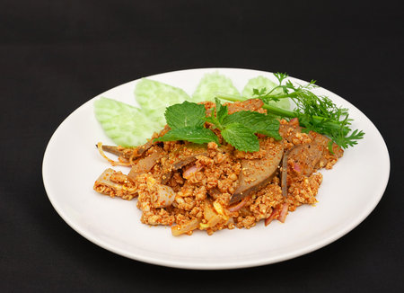 Spicy minced pork salad on white plate.の写真素材