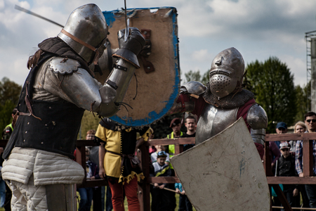 Knight tournament. The knights in the congregations are fighting in the ring. Public event in the...