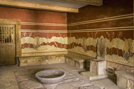 Palace of Knossos, throne room. Walls decorated with ancient frescoes. Royal throne in front of a mysterious bowl.のeditorial素材