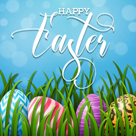 Happy Easter background with colored eggs in the grass on blue sky background