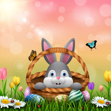 Cute Easter bunny in a basket with colorful eggs on the grassのイラスト素材