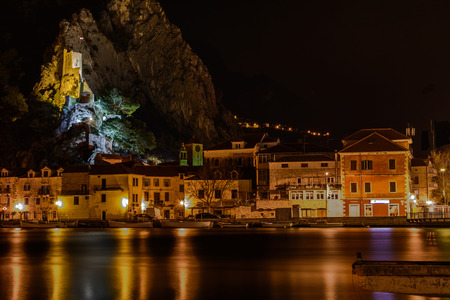 Old dalmatian town Omis at night, waterfront cityscape.