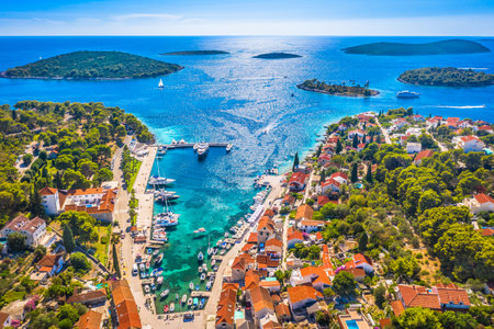 A stunning aerial view of Maslinica on Å olta Island, Croatia, showcasing its picturesque harbor, charming village center, and the scenic archipelago of small islands in frontの写真素材