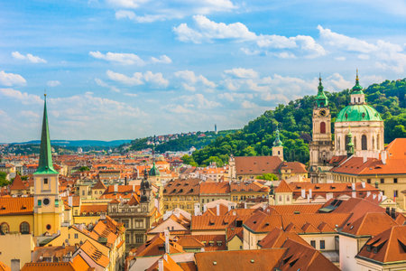 A breathtaking panoramic view of Prague, Czech Republic, known as the City of a Hundred Spires, captured from the viewpoint of St. Vitus Cathedral, showcasing its historic rooftopsの写真素材