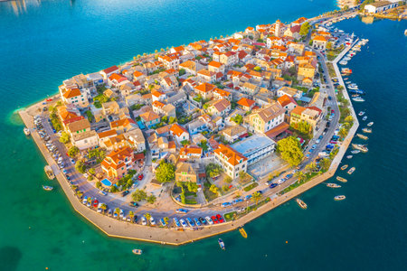 A stunning aerial view of Vranjic Peninsula near Split, Croatia, showcasing its picturesque coastal setting, traditional Mediterranean architecture, and the surrounding blue watersの写真素材