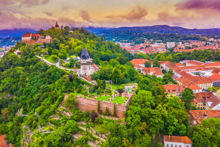 A stunning aerial view of the scenic promenade leading to the historic Clock Tower in Graz, Austria, capturing the charming pathway and panoramic cityscape of this beautiful cityの写真素材