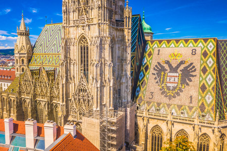 A breathtaking close-up aerial view of St. Stephenâs Cathedral in Vienna, Austria, showcasing its intricate Gothic facade, and vibrant tiled roof, highlighting the beauty of placeの写真素材
