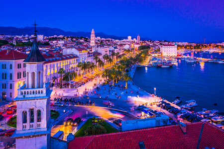 A breathtaking nighttime view of the illuminated Riva promenade in Split, Croatia, showcasing its vibrant waterfront, and historic architecture, capturing the charm of this placeの写真素材