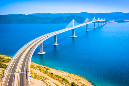 A breathtaking aerial view of the Peljesac Bridge in Croatia, showcasing its impressive modern...