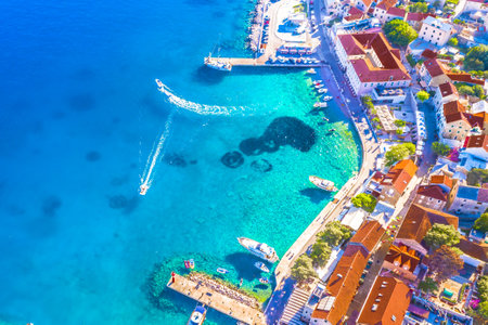 A stunning aerial view of the riva in Bol on Brac Island, Croatia, featuring stone buildings, moored...