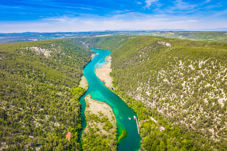 Aerial view of the Krka River in Croatia, a renowned natural getaway known for its emerald waters, scenic waterfalls, and lush green surroundingsの写真素材