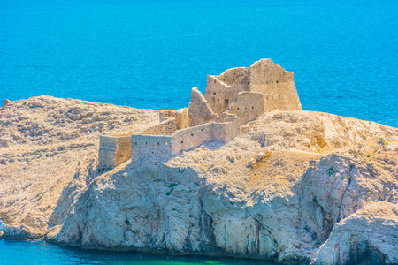 Close-up view of Stone Fort on Pag Island, Croatia, showing the stone structure and historic walls and coastal position, surrounded by the stark rocky terrain and clear seaの写真素材