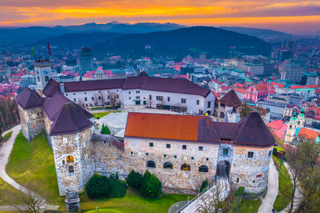 Aerial view of Ljubljana, the capital of Slovenia, showcasing the charming old town with its red rooftops, historic streets, and the iconic sightseeing spot perched on a hill aboveの写真素材