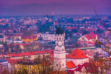 View of the Ljubljanica River flowing through the heart of Ljubljana historical center in Slovenia, lined with charming old buildings, cobbled promenades, and picturesque bridgesの写真素材