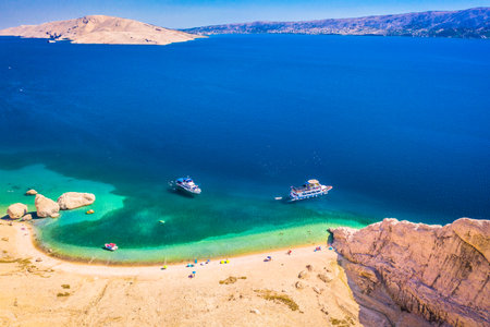 Drone photo of Beritnica beach on Pag island capturing the iconic rock formations, vivid turquoise...