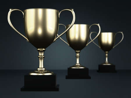Golden cup trophies isolated on a dark background.の写真素材