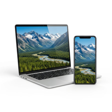 Laptop and smartphone displaying mountain landscape, isolated on white backgroundの素材