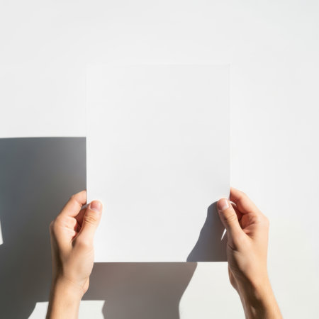 Hands holding paper, isolated on white backgroundの素材