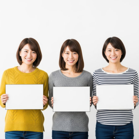 Three women holding signs isolated on white backgroundの素材