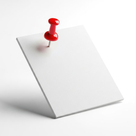 Red pushpin on white paper isolated on white backgroundの素材