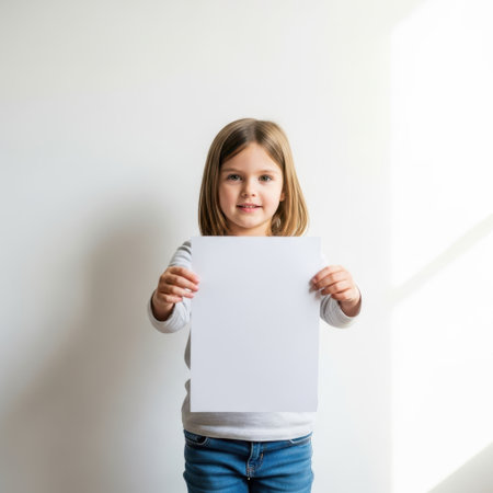 Young girl holding paper isolated on white backgroundの素材