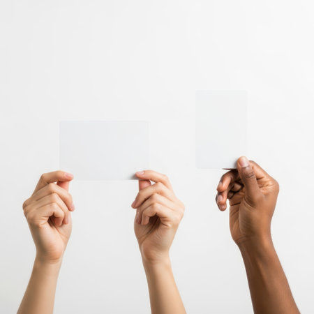Three hands holding objects isolated on white backgroundの素材