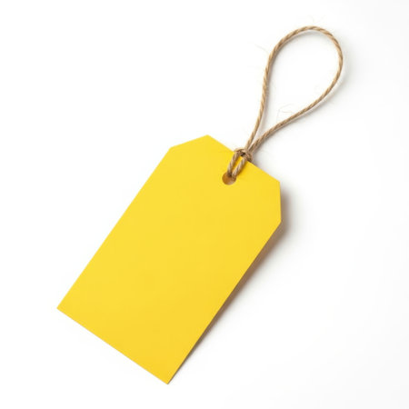 Yellow tag with string, isolated on white backgroundの素材