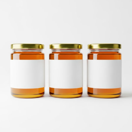 Three honey jars isolated on white backgroundの素材
