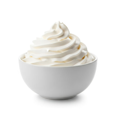 Whipped cream in bowl, isolated on white backgroundの素材