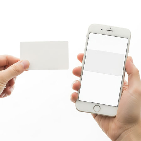 Hand holding smartphone and business card isolated on white backgroundの素材