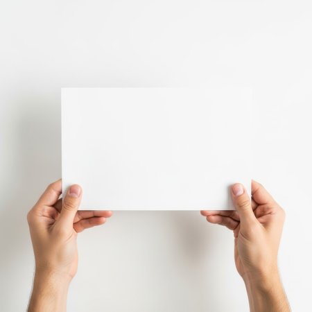 Hands holding paper, isolated on white backgroundの素材