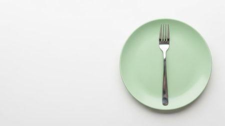 Green plate with fork, isolated on white backgroundの素材