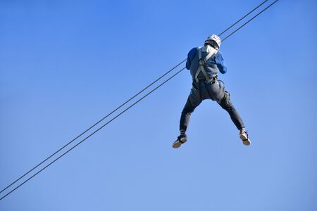 Men enjoy the zip lineの写真素材