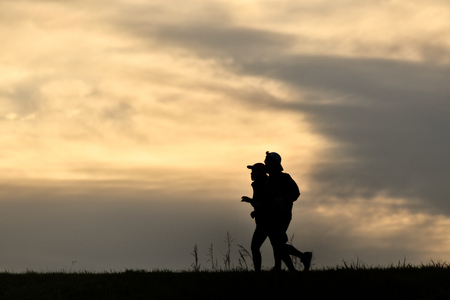 Men and women jogging in the eveningの写真素材