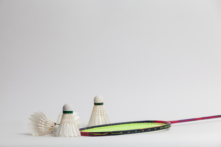 Shuttlecock on badminton racket on white backgroundの写真素材