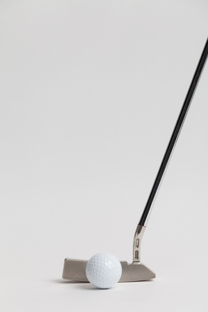 golf ball and putter on White backgroundの写真素材