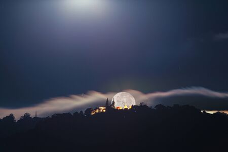 Supermoon Over Wat Phrathat Doi Suthep Temple in ChiangMai, Thailandの写真素材